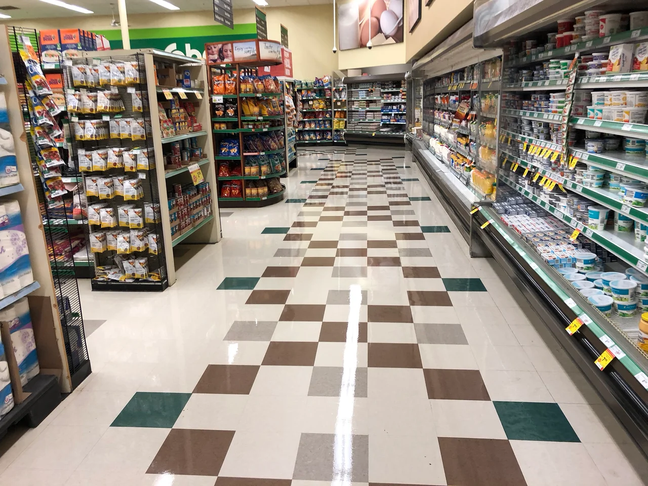 A freshly finished commercial tile floor in a retail aisle